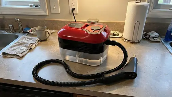 Official merchant image of the Power Blast Plus steam cleaner resting on a kitchen counter