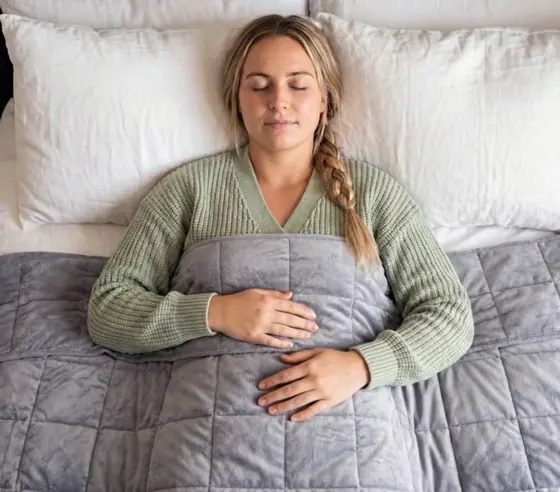 Official image of a grey Velin weighted blanket spread on a bed
